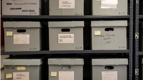 Stacks of boxes with labels identifying documents contained inside.