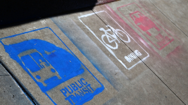 sidewalk painted with public transit signs