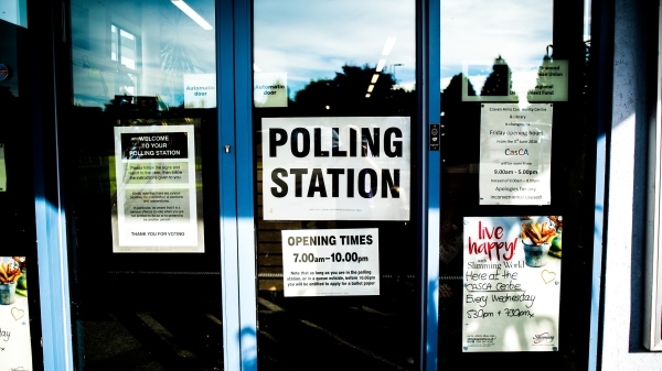 sign on door that says, 'polling station'