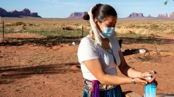 iStock photo of a Navajo woman using hand sanitizer
