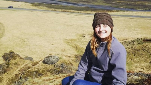 woman smiling with landscape in the background