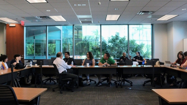 People sitting at a large conference table.