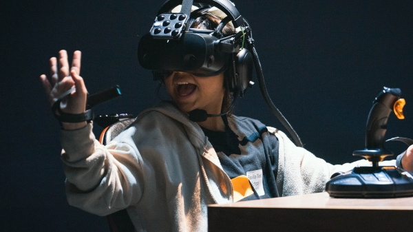 Student wearing a VR headset while looking at their hand.