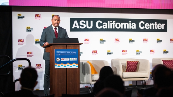 A man speaks at a lectern