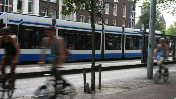 Bikes and a tram in a city.