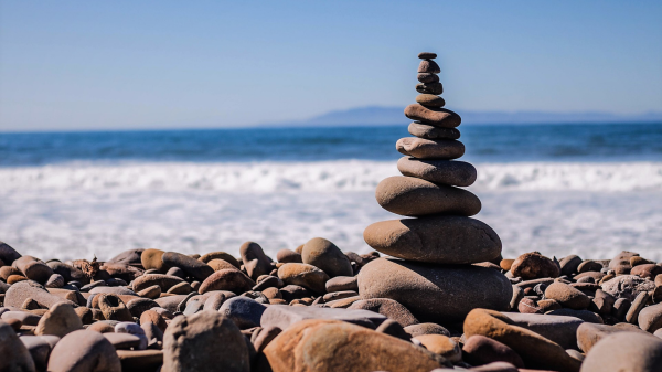 Stock image: stacked stones with ocean in the background