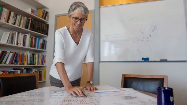 Stephanie Forrest looks over a poster of the internet chokepoint research she is working on.