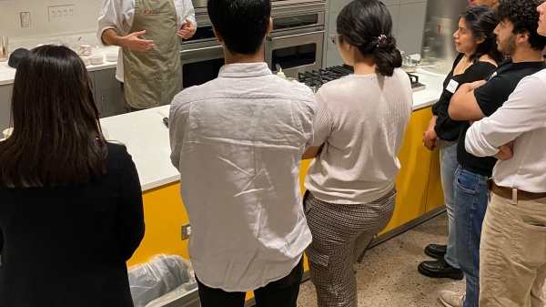 Chef speaking to students in a kitchen.