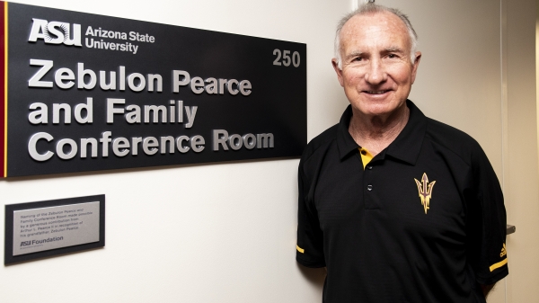 Arthur "Art" Pearce II poses in front of the newly-unveiled Zebulon Pearce and Family Conference Room at Armstrong Hall. 