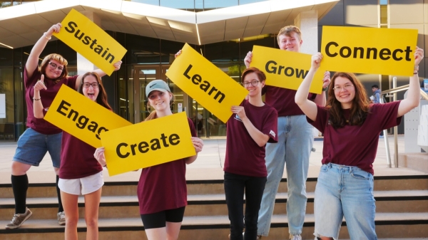 ASU students holding signs that say: sustain, engage, create, learn, grow, connect.
