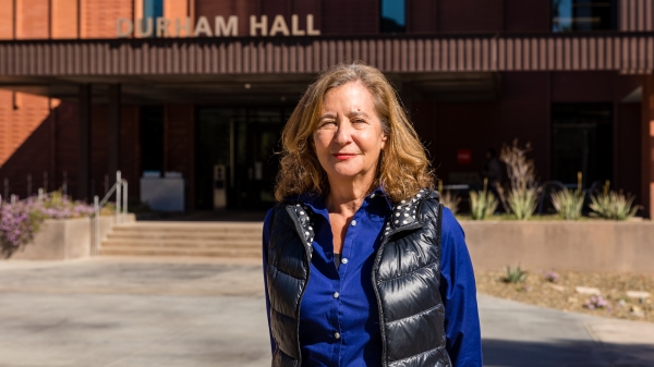 Elisa New stands in front of Durham Hall on the ASU Tempe campus. Photo by Bruce Matsunaga/ASU.