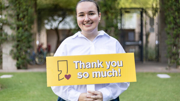 ASU student Emra Muslim holding a sign that reads "Thank you so much!"