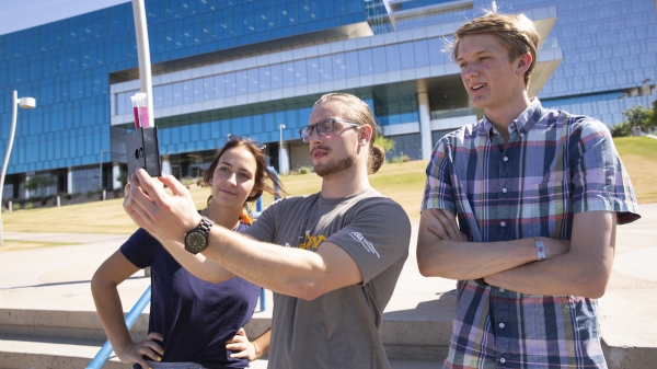 Three students test water quality