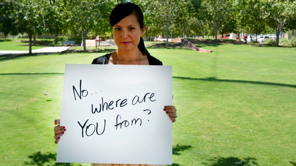 woman holding a sign displaying a "microaggression"