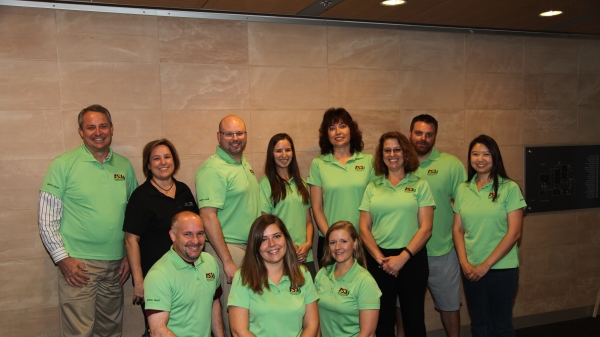 group of people in green polos