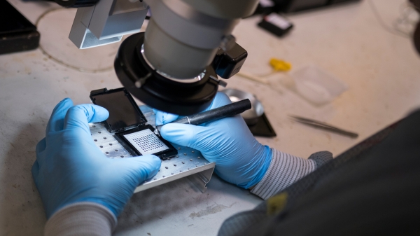 hands assembling nanotech under light