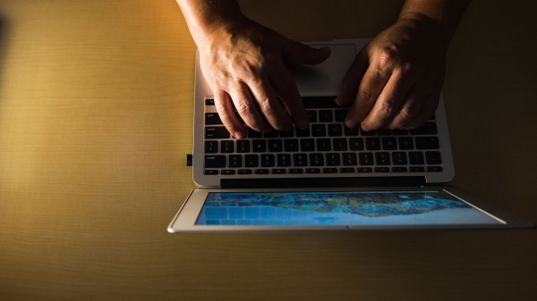 A pair of hands on a keyboard