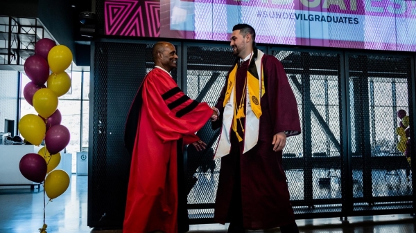 Man shaking hands with graduate