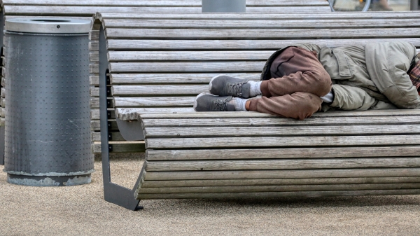 Person sleeping on a bench.