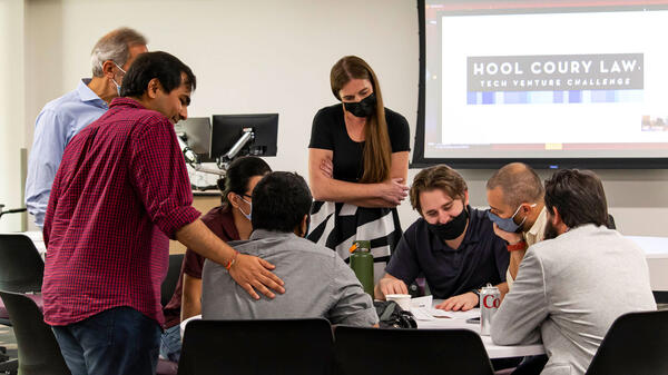 A group of student entrepreneurs work together at the Hool Coury Law Tech Venture Showcase.