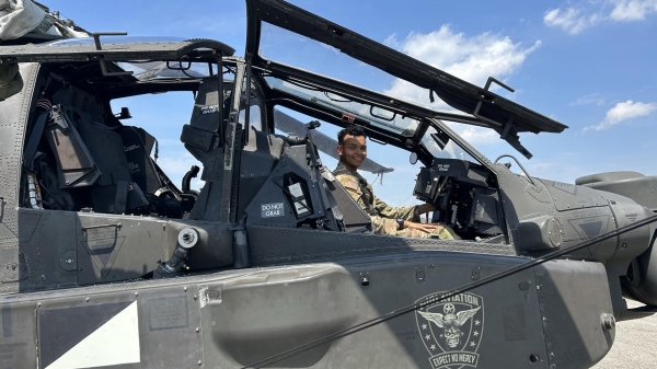 ASU ROTC student Jose Gonzalez in an Apache helicopter.