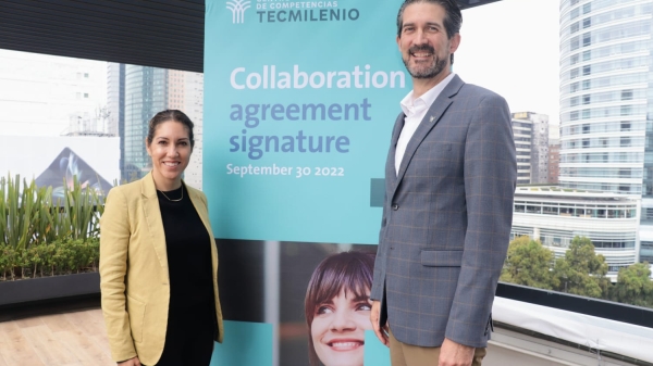 Woman and man standing on either side of a banner that reads "Centro de Competencias Tecmilenio collaboration agreement signature September 30 2022."