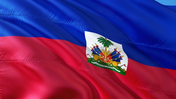 The Haitian flag behind a blue sky