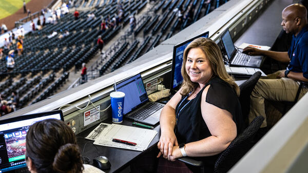 ASU alum Kara Blackstone seated in the stands of a baseball field. 