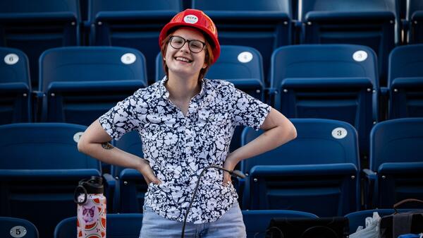 Krys Newbury standing with hands on hips in front of theater seats