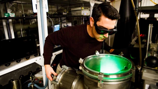 A student researcher in Scott Sayres' laboratory uses safety gear developed at ASU to conduct experimental research using ultrashort laser pulses.