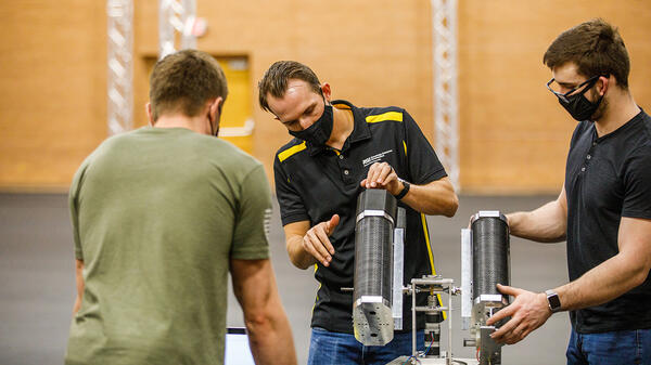 Team members calibrate the launcher in the Drone Studio.