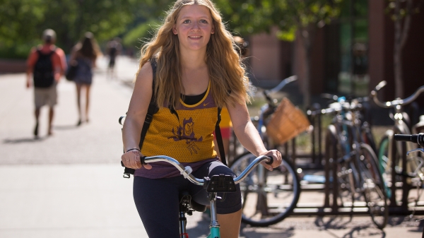 woman riding bike on university campus