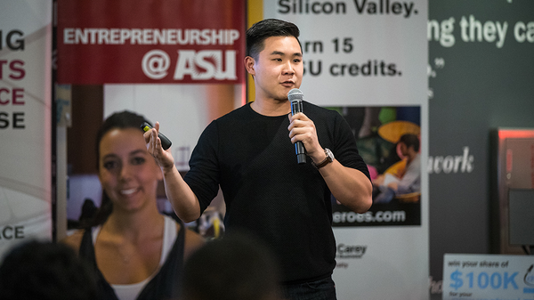 Man speaking into a microphone at an ASU entreprenership event.