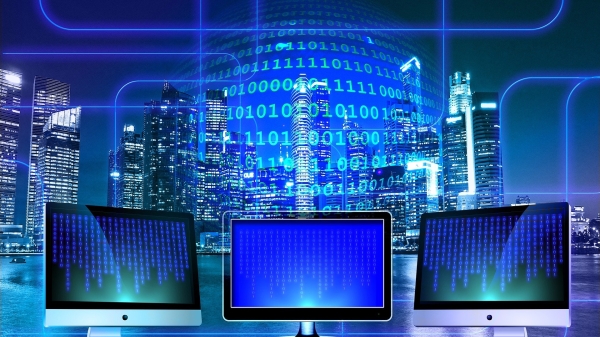 abstract image with computer screens in foreground and a city scape in the background