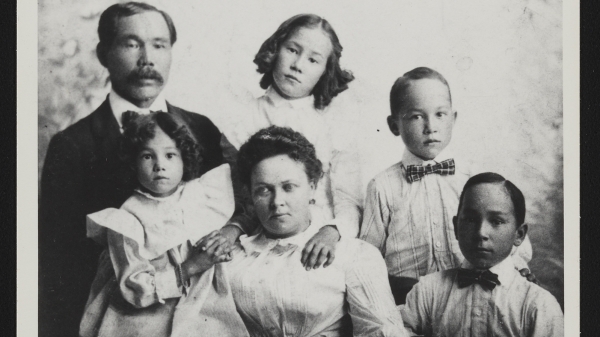 Black and white archival photograph of parents and four children