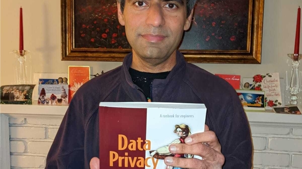 Nishant Bhajaria holding his book "Data Privacy"