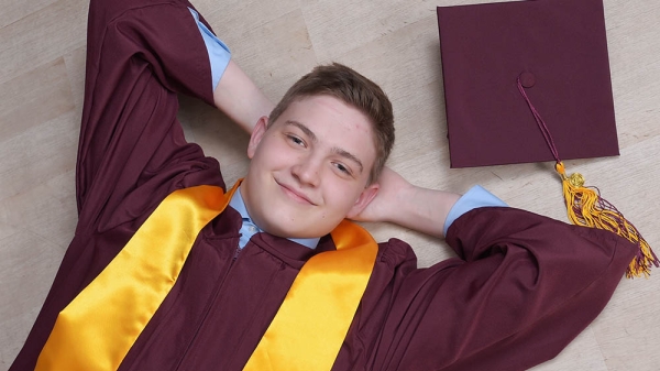 ASU graduate Nathan Reed with academic regalia