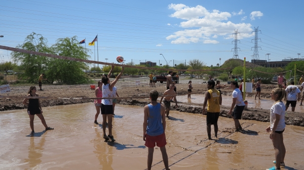 students playing mud volleyball