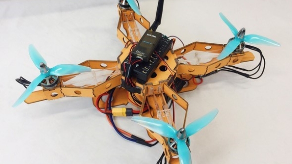 Image depicts a quadrotor prototype with controller on the top