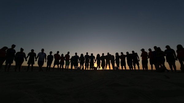 people in a line holding hands