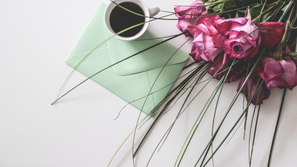 Flowers, card and coffee on a table