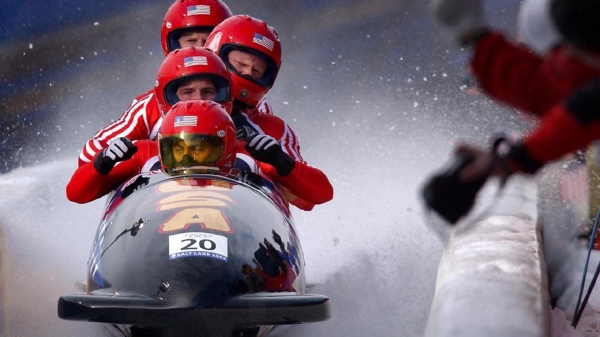 Four USA athletes in a bobsled at the 2002 Winter Olympics.