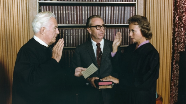 Sandra Day O Connor is sworn in by Chief Justice Warren Burger as her husband watches on Sept 25 1981