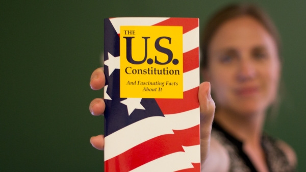 woman holding pocket US Consititution