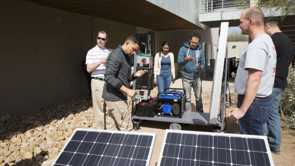 people working with solar panel