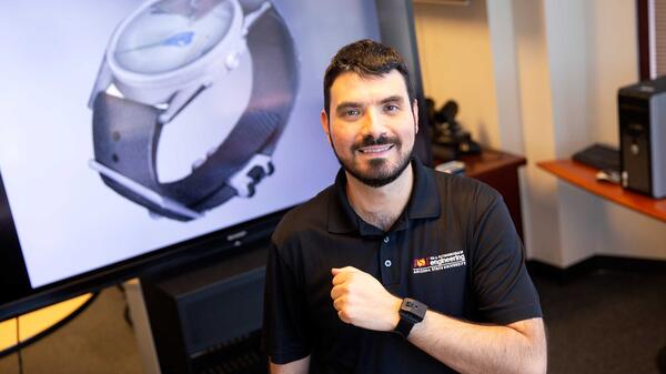 ASU Assistant Professor Troy McDaniel wearing a watch-like device on his wrist.