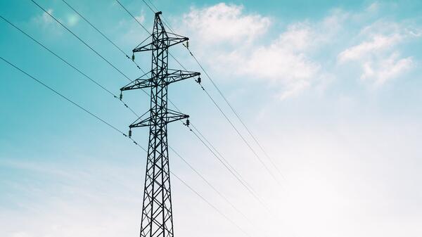 Power lines against a cloudy blue sky