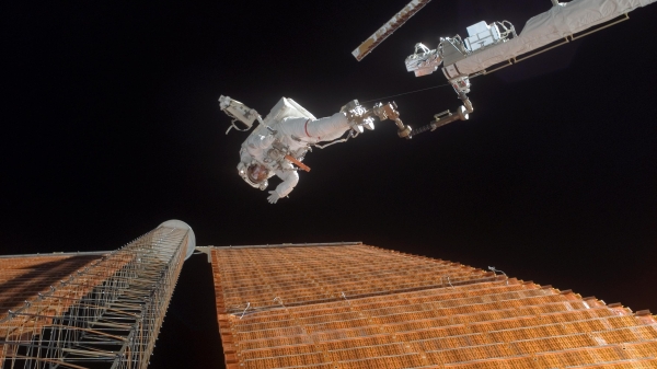 An astronaut floats in space during a space walk maneuver