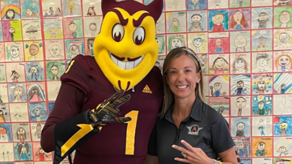 ASU mascot Sparky posing with a local school teacher.