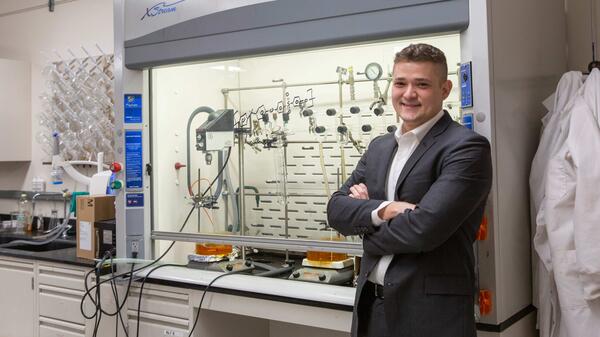 ASU Associate Professor Mathew Green standing with arms crossed and smiling in a laboratory setting.